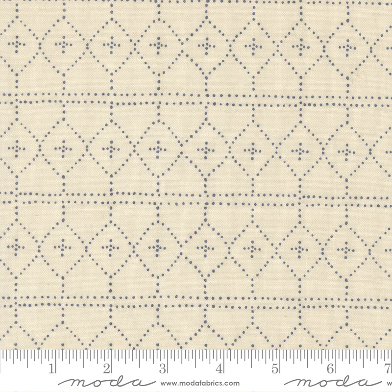 Fabric with a diamond pattern and ruler for scale on a beige background
