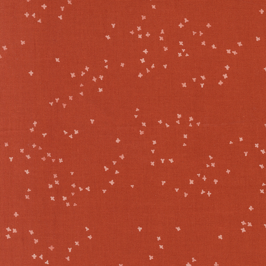 Red fabric with small white floral patterns