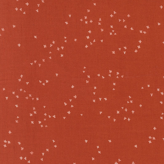 Red fabric with small white floral patterns