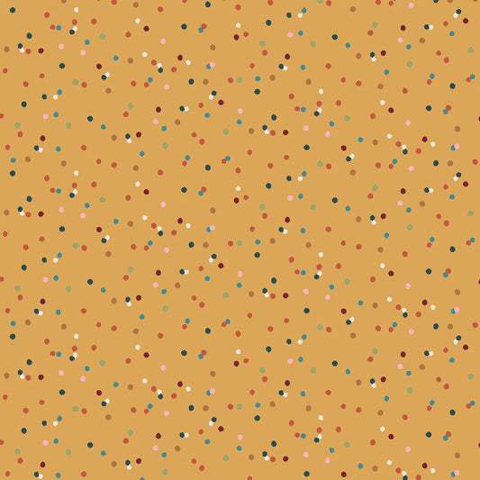 A repeating pattern of small multicolored confetti dots on a warm gold yellow background.