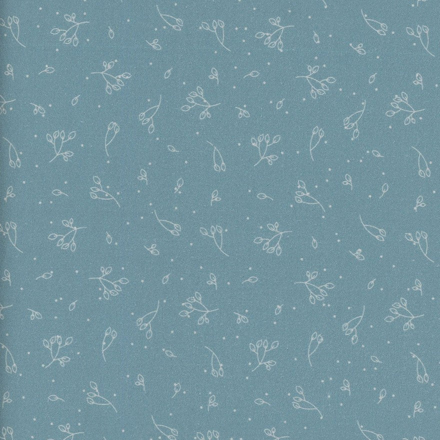 Patterned fabric with small white floral designs on an aqua blue background