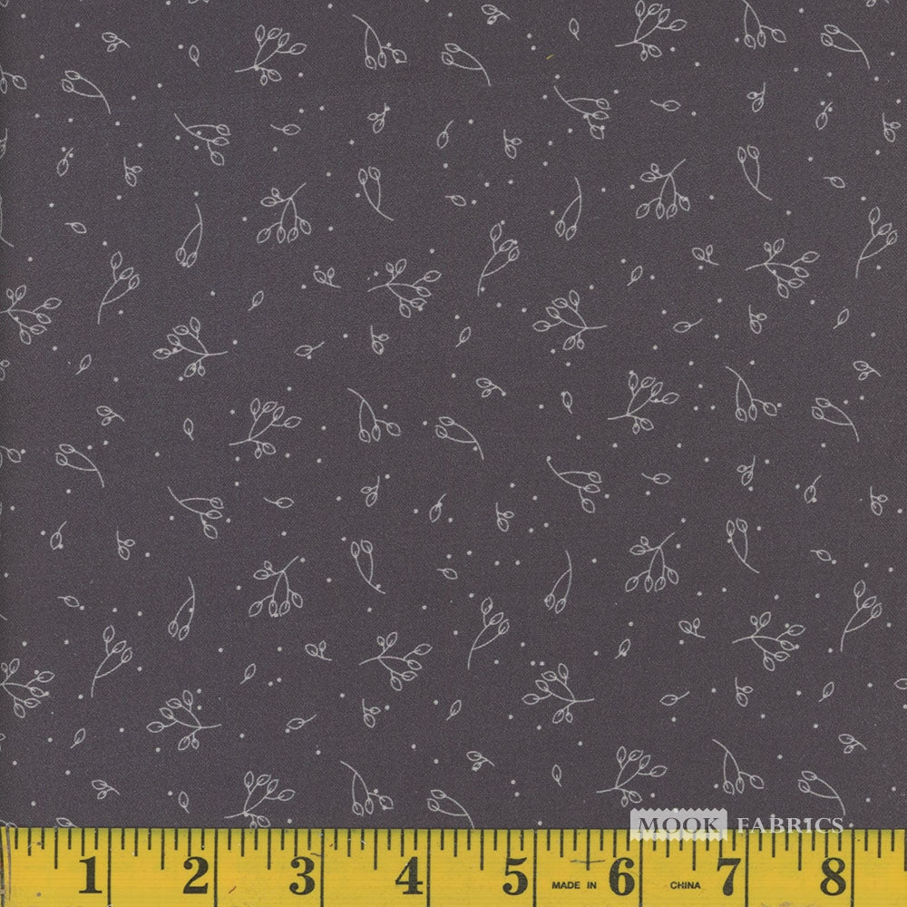 Dark grey fabric with white floral pattern and a ruler at the bottom for scale.