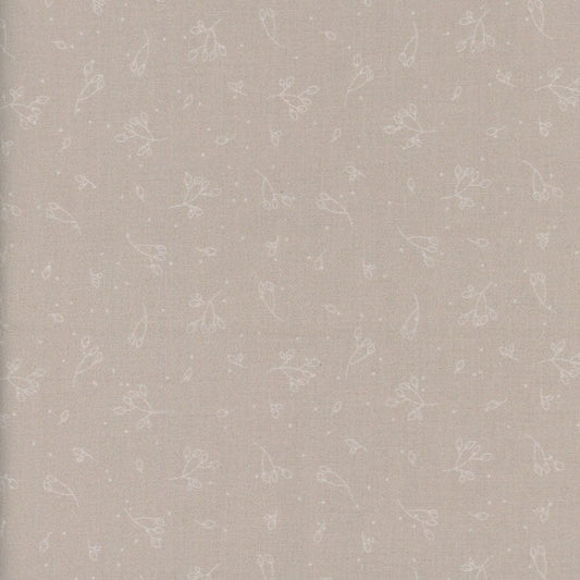 Patterned wallpaper with small floral designs on a light beige background