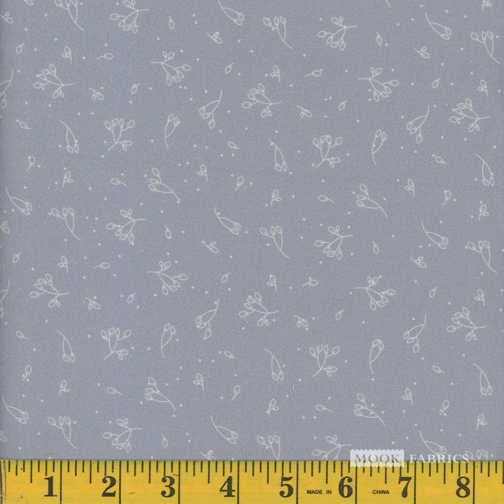 Fabric with subtle floral pattern on a blue background, measured with a ruler at the bottom.