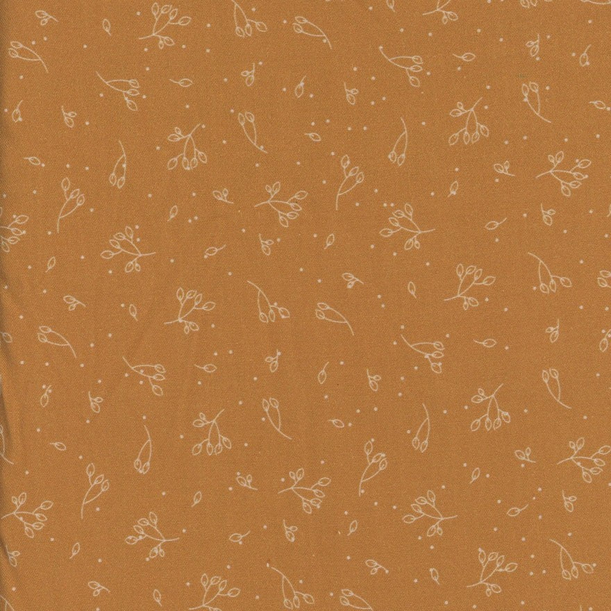 Mustard yellow fabric with small white floral pattern