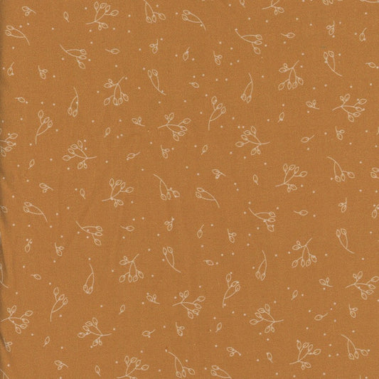Mustard yellow fabric with small white floral pattern