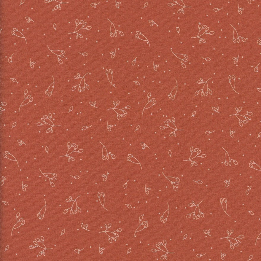 Dark orange fabric with small white floral pattern
