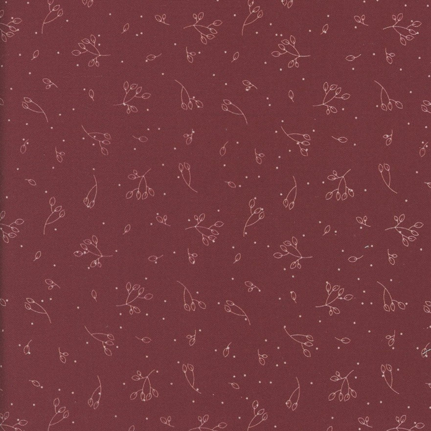 Patterned fabric with small floral designs on a red-brown background