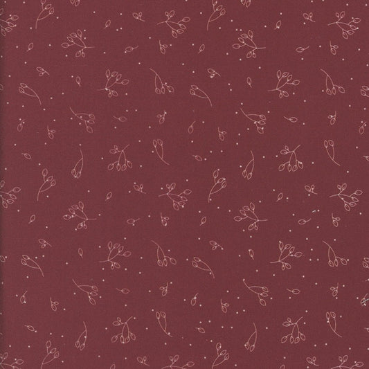 Patterned fabric with small floral designs on a red-brown background