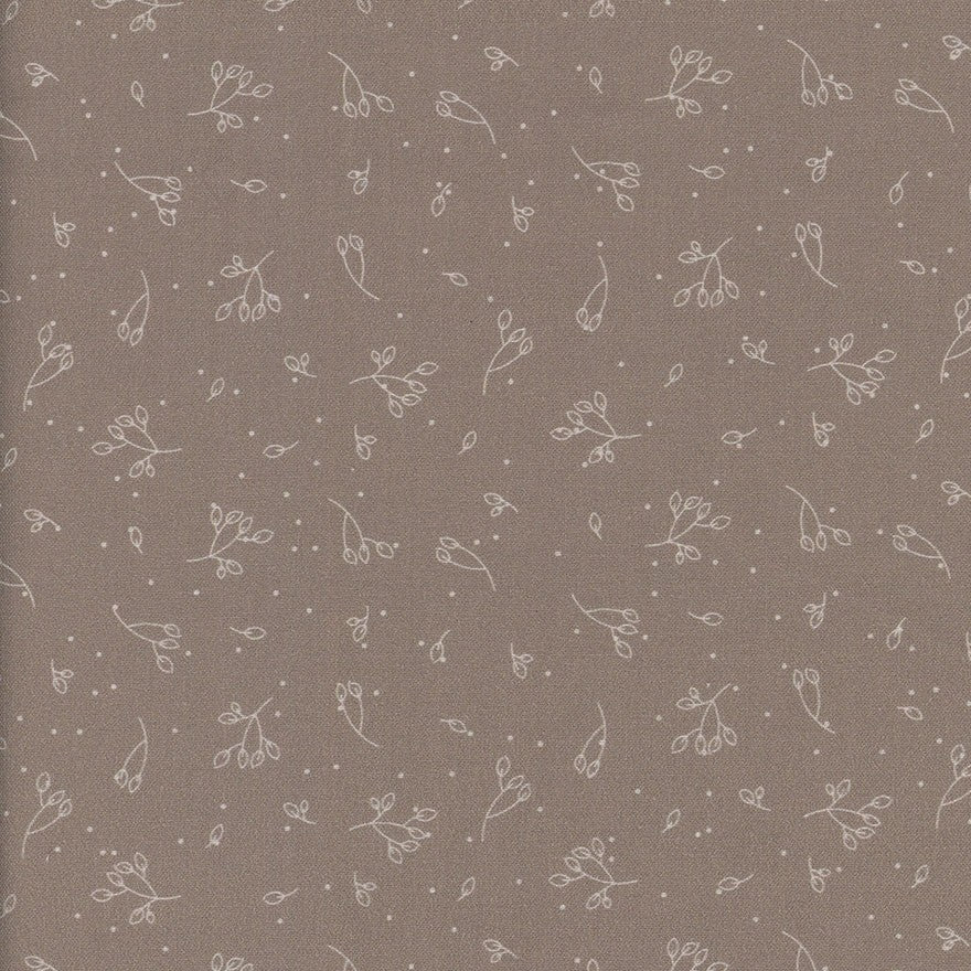 Patterned fabric with small floral designs on a brown background