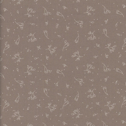 Patterned fabric with small floral designs on a brown background