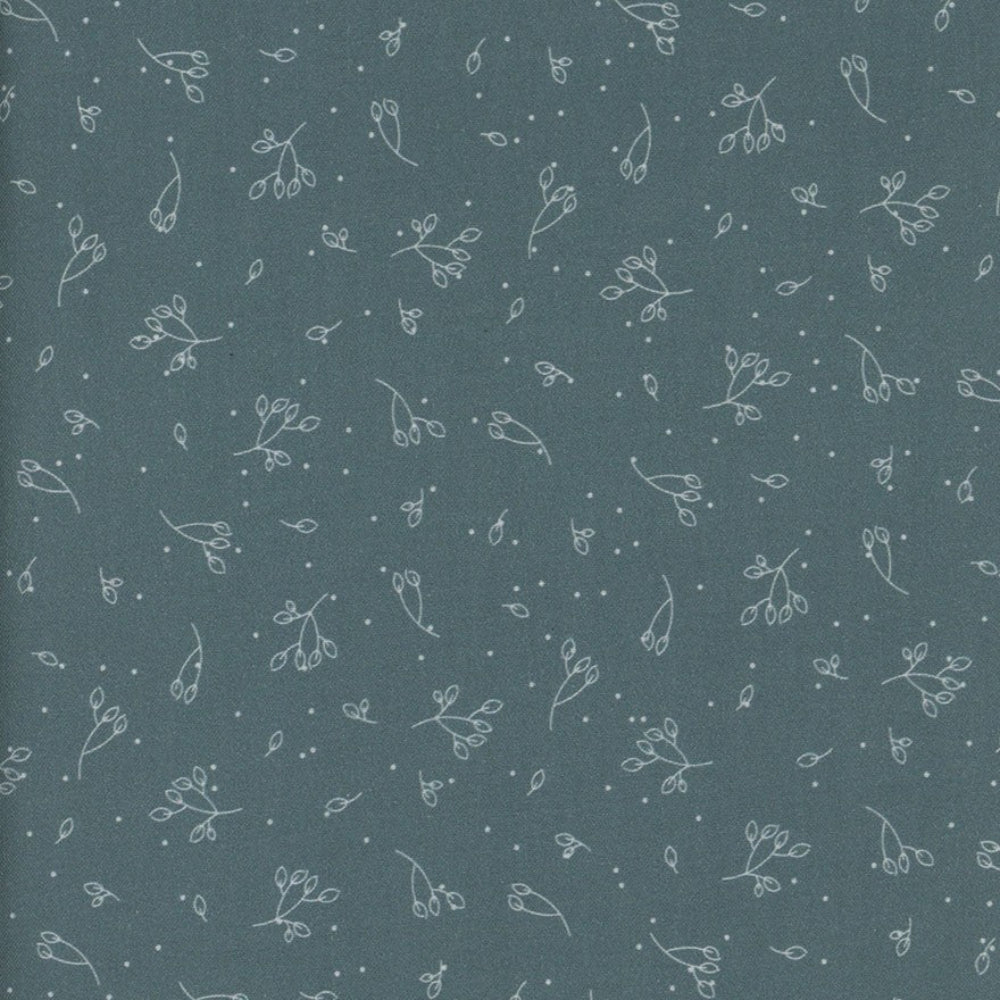 Patterned fabric with small floral designs on a dark teal blue background