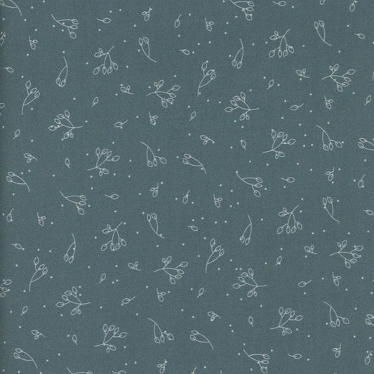 Patterned fabric with small floral designs on a dark teal blue background